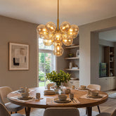 Gold amber glass chandelier in modern dining room