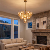 Gold amber chandelier in stone fireplace living room