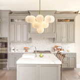 Gold bubble chandelier in light gray kitchen