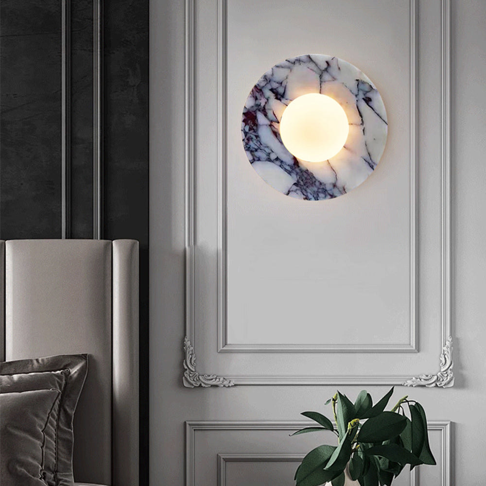 Marble wall sconce above luxury bedroom headboard