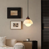 Modern marble and wood pendant light installed in a minimalist living room