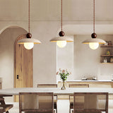 Dining room with 3 travertine pendant lights, wabi-sabi style