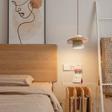 Natural wood travertine pendant light over rattan bed