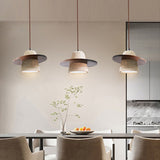 3 walnut brown travertine pendant lights in dining room