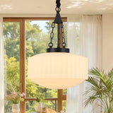 Lit black milk glass pendant light in sunlit space