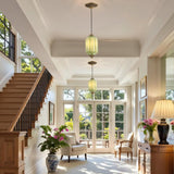 Vintage green glass pendant lights in a bright entryway with staircase