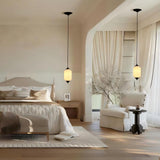 White glass pendant lights in a cozy bedroom with reading nook