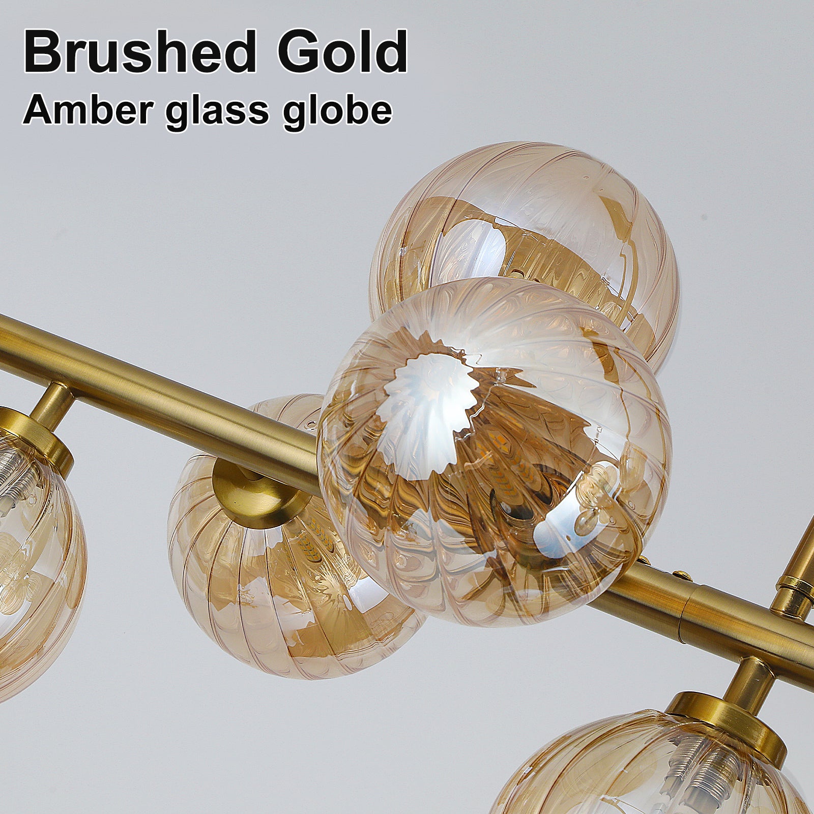  Close-up brushed gold frame ribbed amber textured glass globe chandelier detail shot