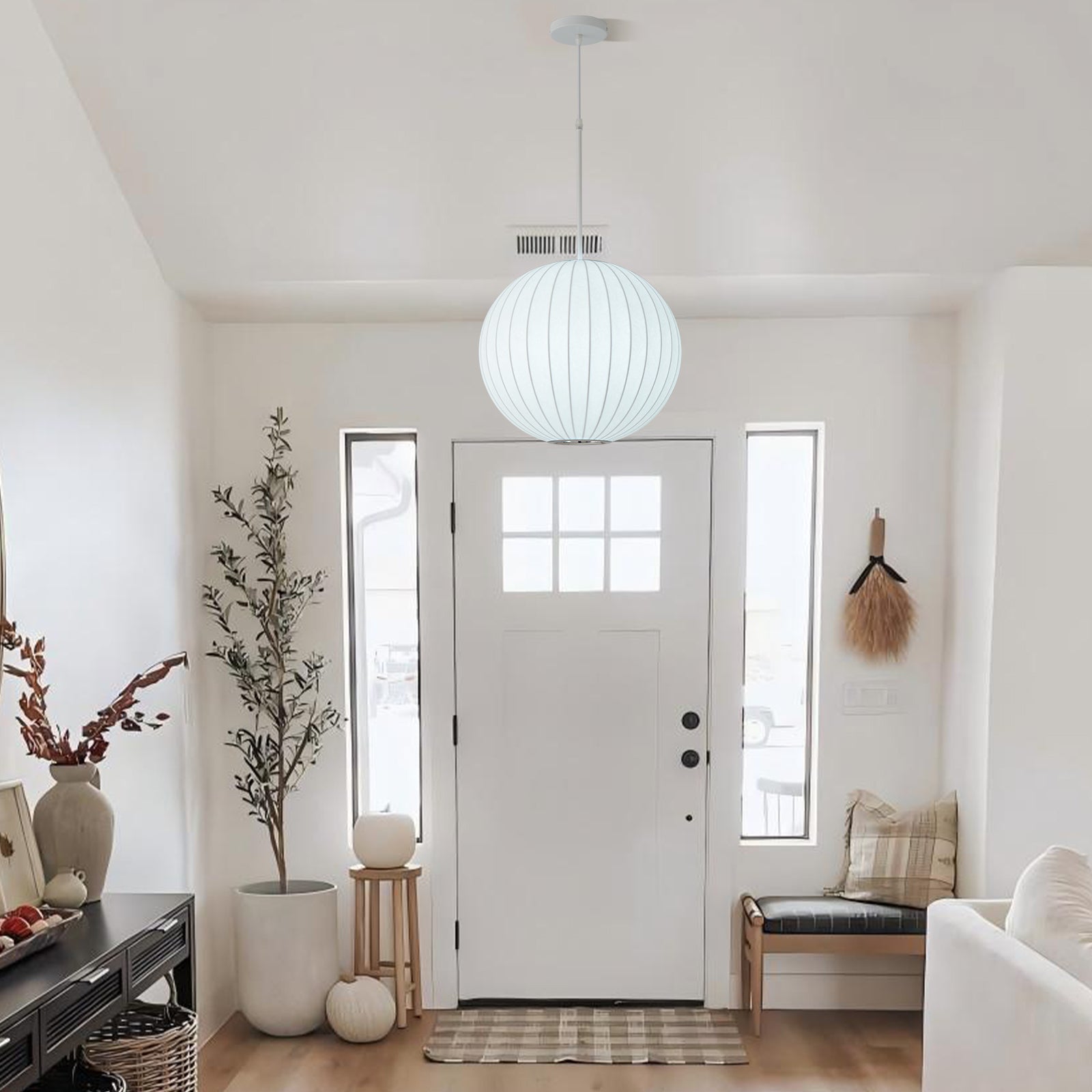 Round pendant lamp hanging above front entry doorway foyer decoration