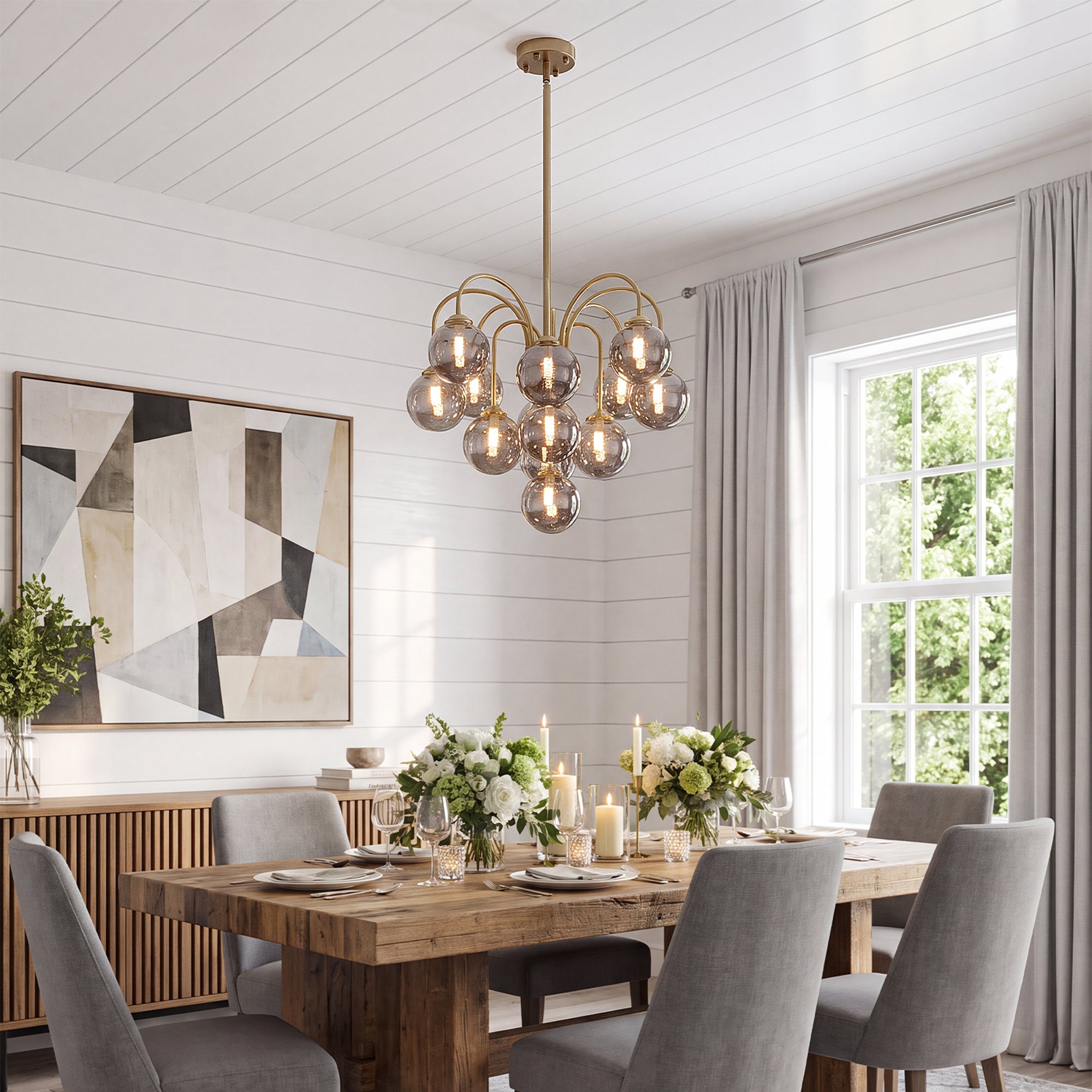 Mid century brushed gold smoke glass globe sputnik chandelier above wooden farmhouse dining table