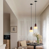 Two wabi-sabi stone wood pendant lights in bright living room.