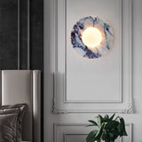 Marble wall sconce above luxury bedroom headboard