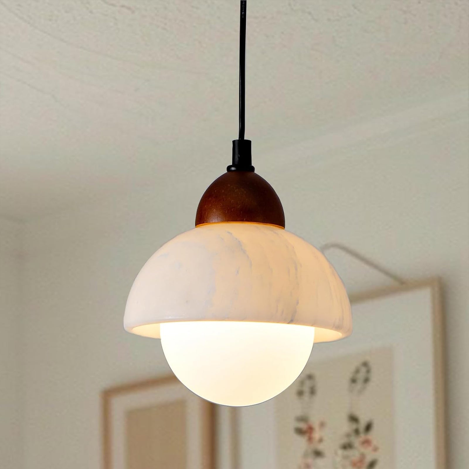 Close-up of the natural marble lampshade and wooden top of the pendant light