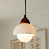 Close-up of the natural marble lampshade and wooden top of the pendant light