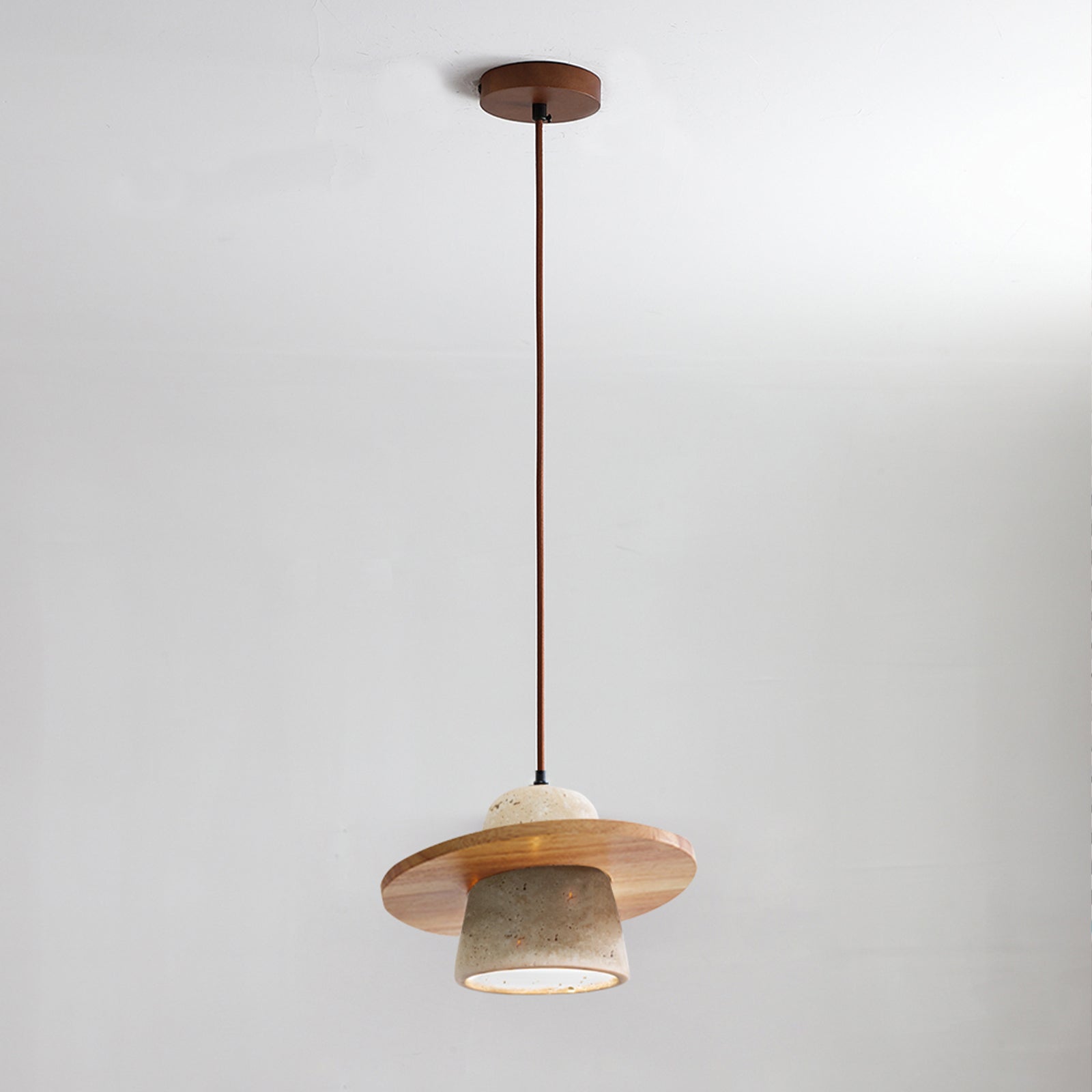 Natural wood travertine pendant light by bedside table