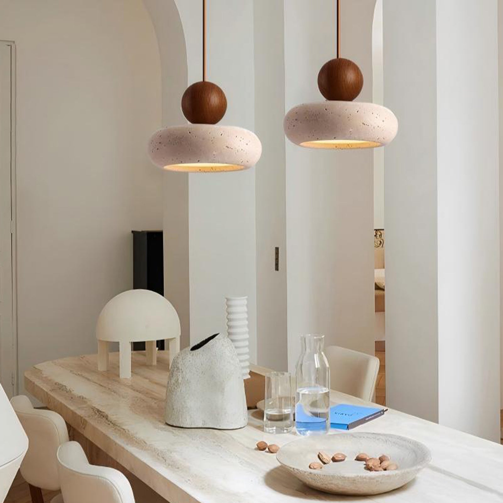 Brown wood & travertine pendant lights in modern dining room, warm light