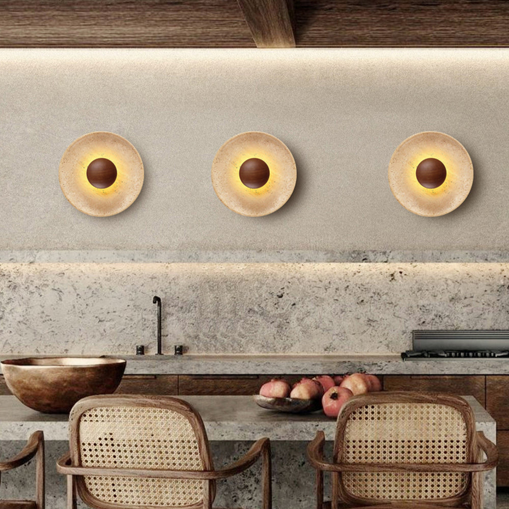 Three travertine wood LED wall sconces above kitchen countertop