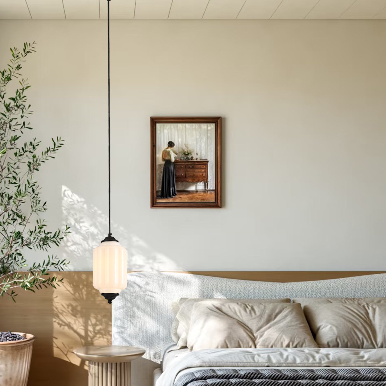 Vintage white pendant light above a bed with wall art decor